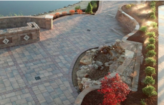 Picture of a commercial pavers project along the side of a city lake, including retention walls and walkways.